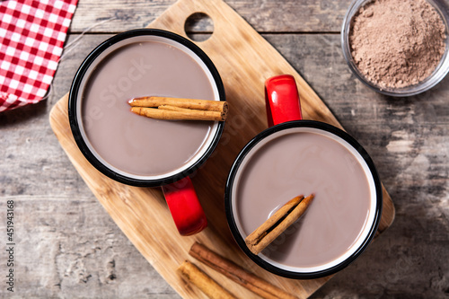 Traditional Mexican chocolate atole drink on wooden table. Top view photo