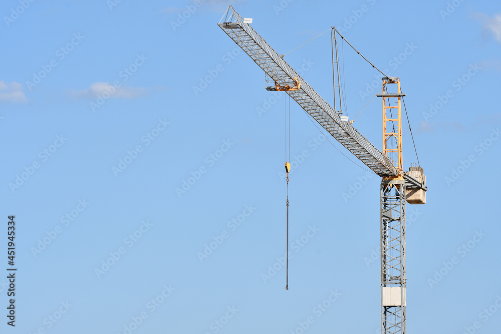 crane against blue sky in a construction site crane against blue sky in a construction site