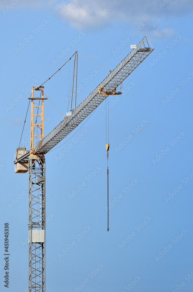 crane against blue sky in a construction site crane against blue sky in a construction site