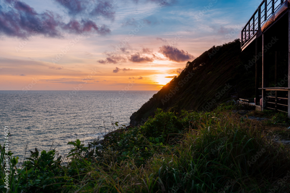 view above cliffs and sea from top hill in evening with beautiful sunset twilight sky, sky view, sunshine viewpoint in Phasuk nirun, Ko Proet, in Chanthaburi, Thailand