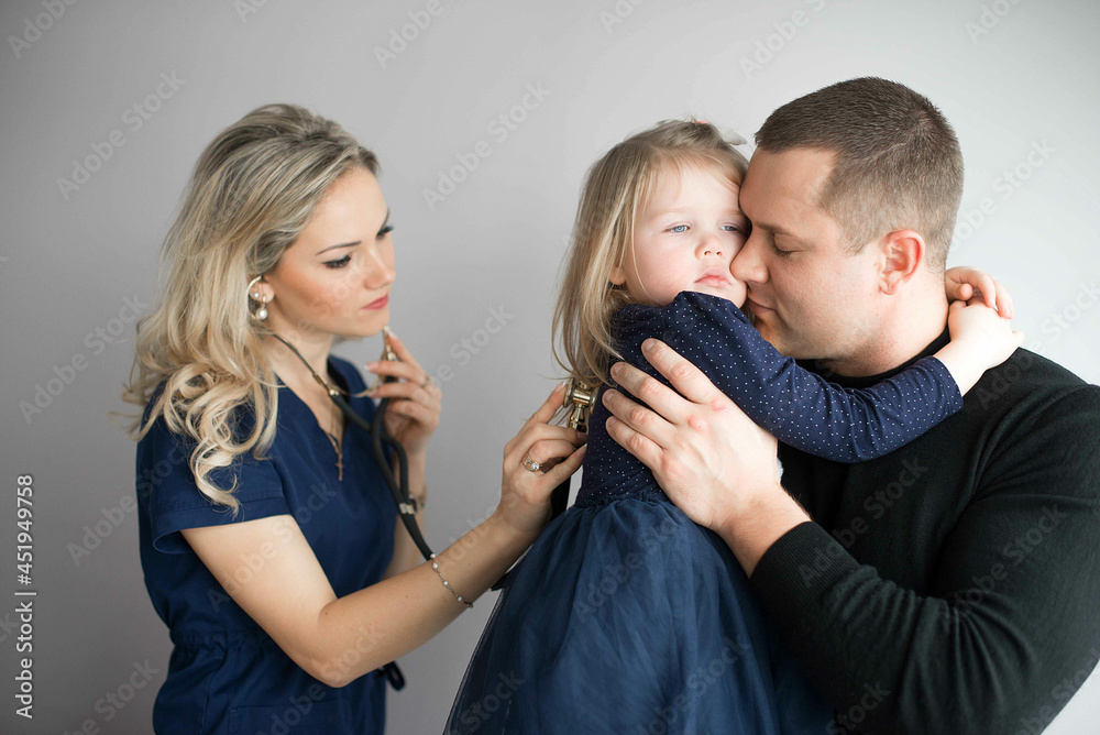 Father with girl being examined by female pediatrician in clinic Father with girl being examined by female pediatrician in clinic