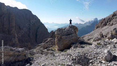 Hiker enjoying the view high up in the dolomite mountains
