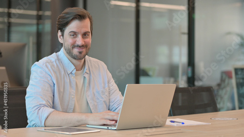 Man with Laptop Shaking Head as No Sign
