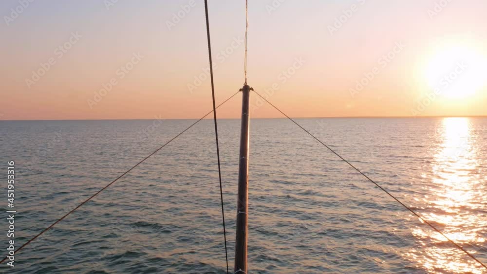 Ship's bow moving through the waves view from forecastle deck 4K. Boat sailing on blue purple sea water Beautiful orange sunset evening marine landscape with clear colorful sky. Maritime vacation. Ship's bow moving through the waves view from forecastle deck 4K. Boat sailing on blue purple sea water Beautiful orange sunset evening marine landscape with clear colorful sky. Maritime vacation.