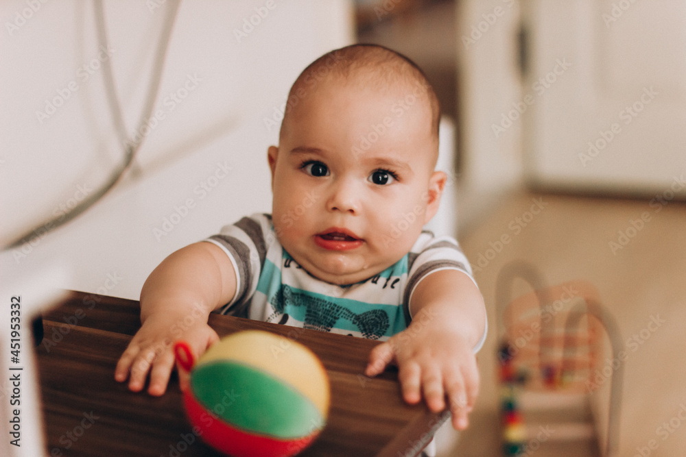 Portrait of cute baby close-up. Sweet little infant looks to camera. Bald baby with brown eyes and long lashes Portrait of cute baby close-up. Sweet little infant looks to camera. Bald baby with brown eyes and long lashes
