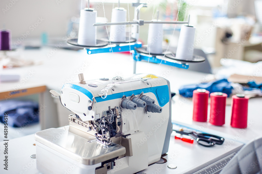 Interior of garment factory . Closes making atelier with several sewing machines. Tailoring industry, fashion designer workshop, industry concept