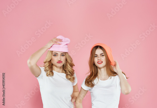 women girlfriends in white t-shirts youth style Glamor pink background
