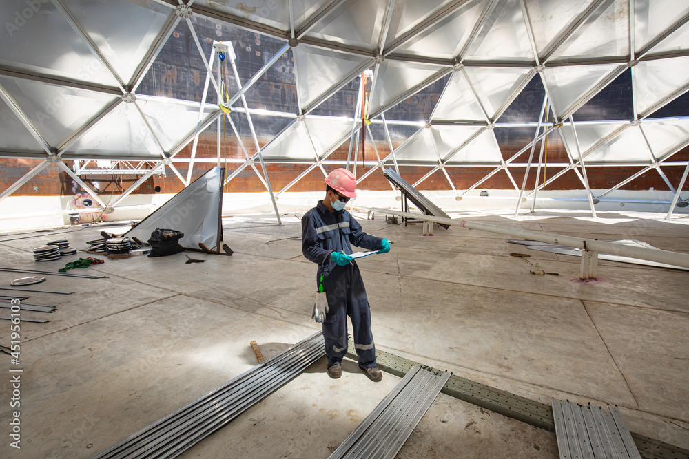 Male worker file record visual inspection tank dome aluminum into the confined space