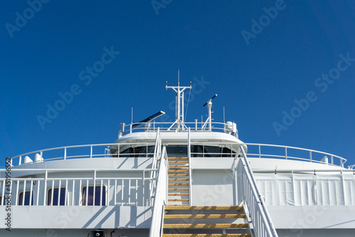 Modern Ferry Ship Deck Control and Exterior against Blue Sky. Marine Traffic. 
