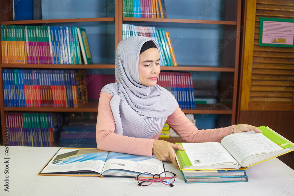 islamic woman reading book on the desk islamic woman reading book on the desk