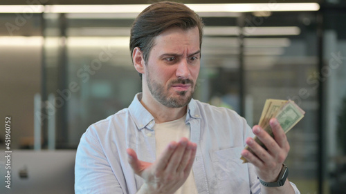 Portrait of Mature Adult Man Counting Dollars 