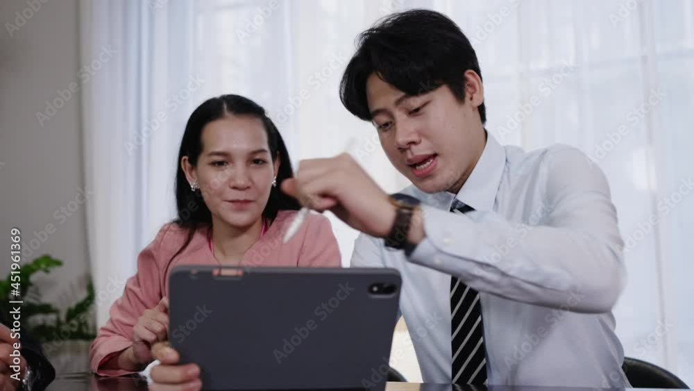 Asian businessman discussing work strategy planning meeting with colleagues. Investment Consulting with Confidence of an Advisor. joint contract between organization. business teamwork Asian businessman discussing work strategy planning meeting with colleagues. Investment Consulting with Confidence of an Advisor. joint contract between organization. business teamwork