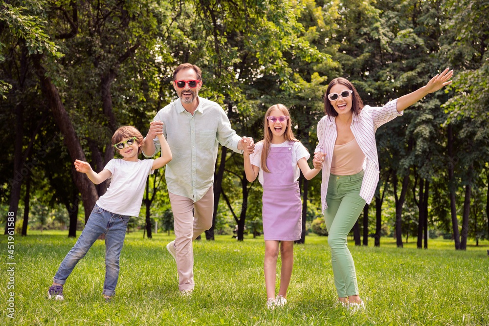 Obraz premium Photo of pretty sweet father mother school girl boy wear casual clothes walking holding arms smiling outdoors countryside forest