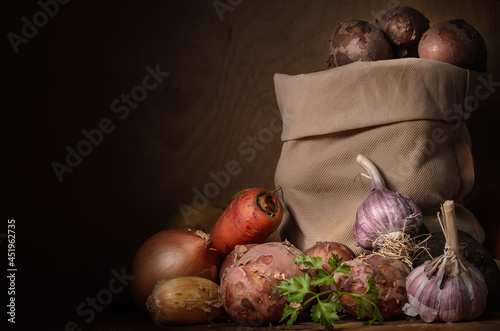 potatoes in a cloth bag and other vegetables