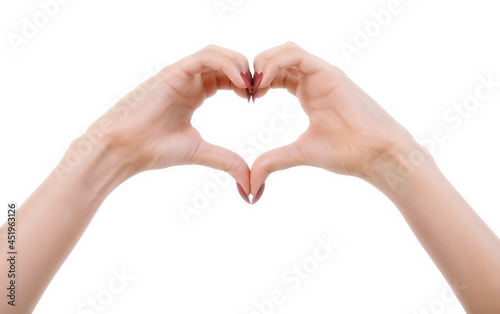 Woman hands making heart sign by fingers. Beautiful female hands showing a heart shape. Hands skin care, nails treatment, love, Valentine day concept. Retouched studio shot, isolated, white background