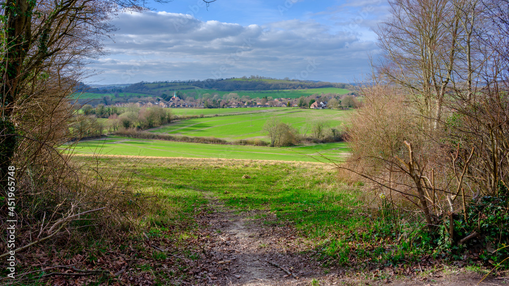 Early spring sunlight and view over the village of South Harting from the South Downs National Park, West Sussex, UK Early spring sunlight and view over the village of South Harting from the South Downs National Park, West Sussex, UK