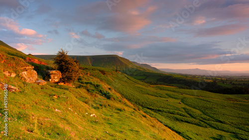 Golden hour sunlight on the view from just below Gospel Pass over the northern foothills of the Black Mountains including the ridge of Lord Hereford's Knob, Wales