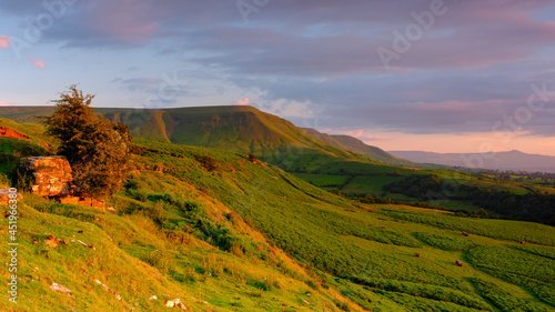 Golden hour sunlight on the view from just below Gospel Pass over the northern foothills of the Black Mountains including the ridge of Lord Hereford's Knob, Wales