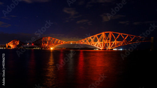 Night view of Forth Ril Bridge from South Queensferry Harbour, Scotland photo