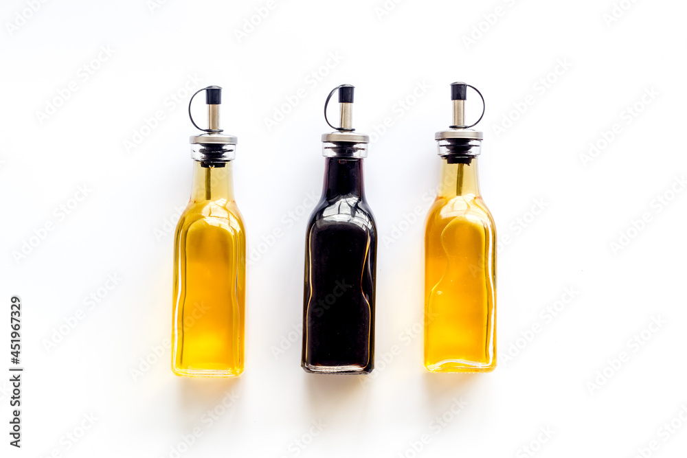 Balsamic and apple cider vinegar in glass bottles top view