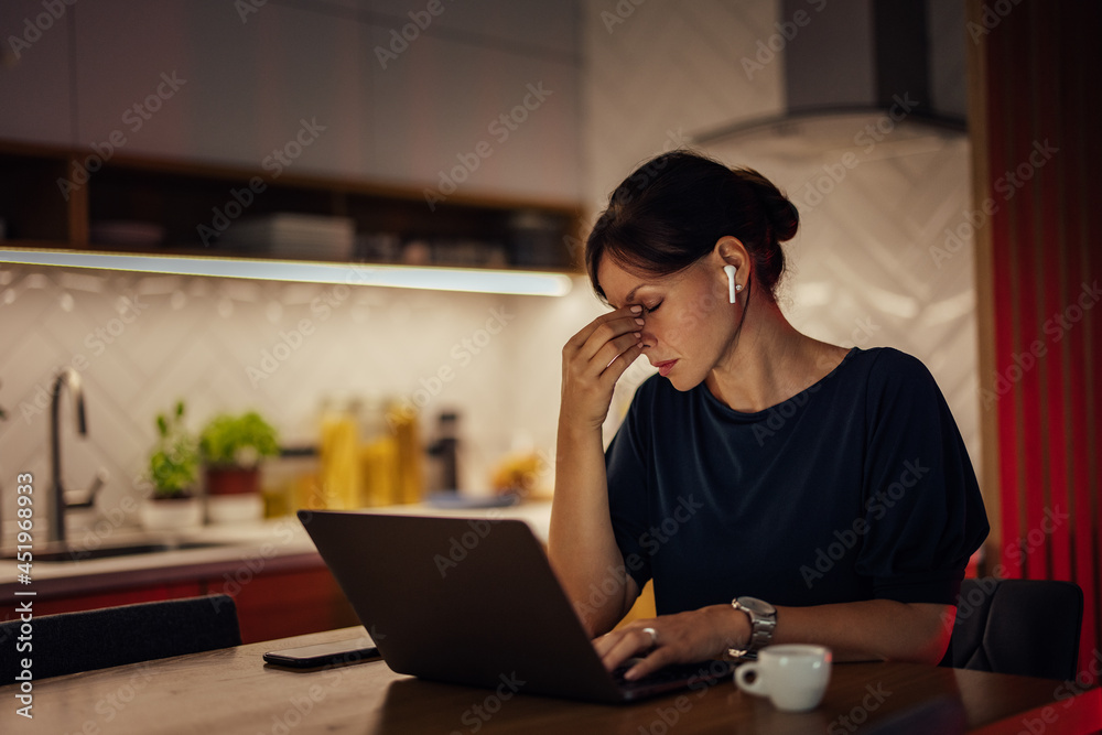 Exhausted woman working on laptop. Tired and overworked. Exhausted woman working on laptop. Tired and overworked.