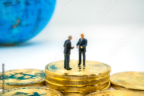 miniature businessman standing at the  bitcoin, future currency