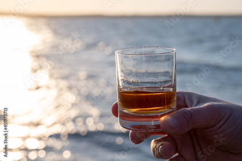 Drinking single malt Scotch whisky at sunset with sea, ocean or river view, private whisky tours in Scotland, UK