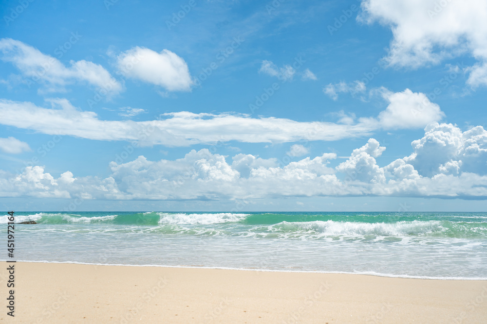 Beautiful air sunlight with blue sky and clouds background.Amazing wave on clean sandy surfing  beach.Seashore waves whitewash.