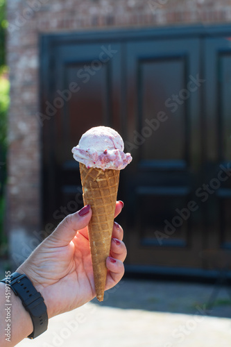 Eating on fresh made italian ice cream on street, summer vacation