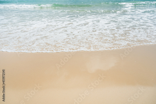 Beautiful waves breaking onto sand.Top view of clear turquoise sea and foamy waves.