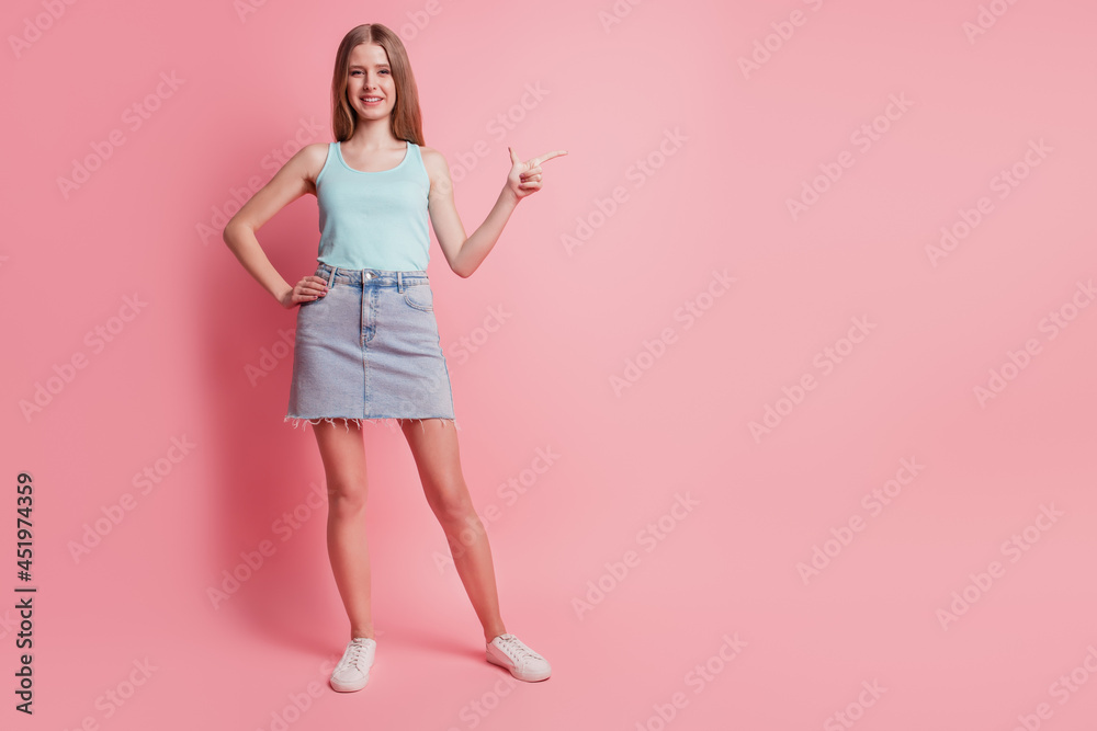 Portrait of reliable charming lady indicate finger blank space on pink background Portrait of reliable charming lady indicate finger blank space on pink background