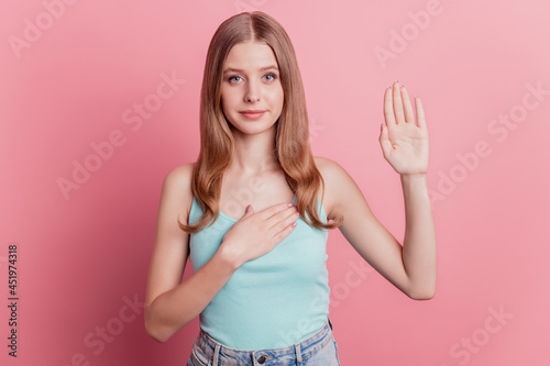 Obraz na płótnie Portrait of independent patriot lady pledge raise hand palm heart on pink backgr