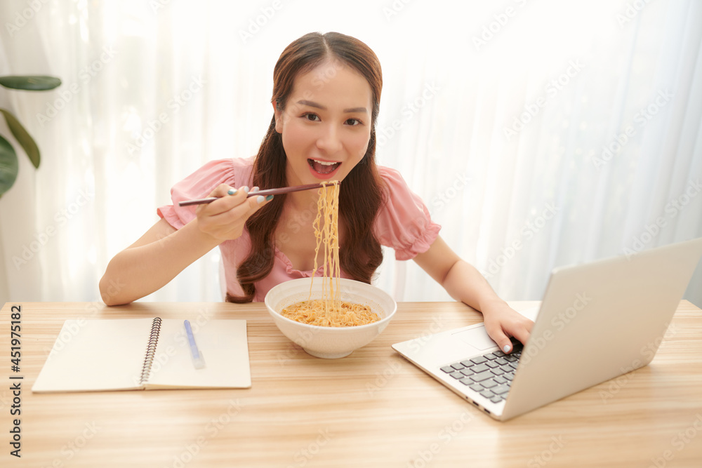 Asian businesswoman has to eat noodles while working Asian businesswoman has to eat noodles while working