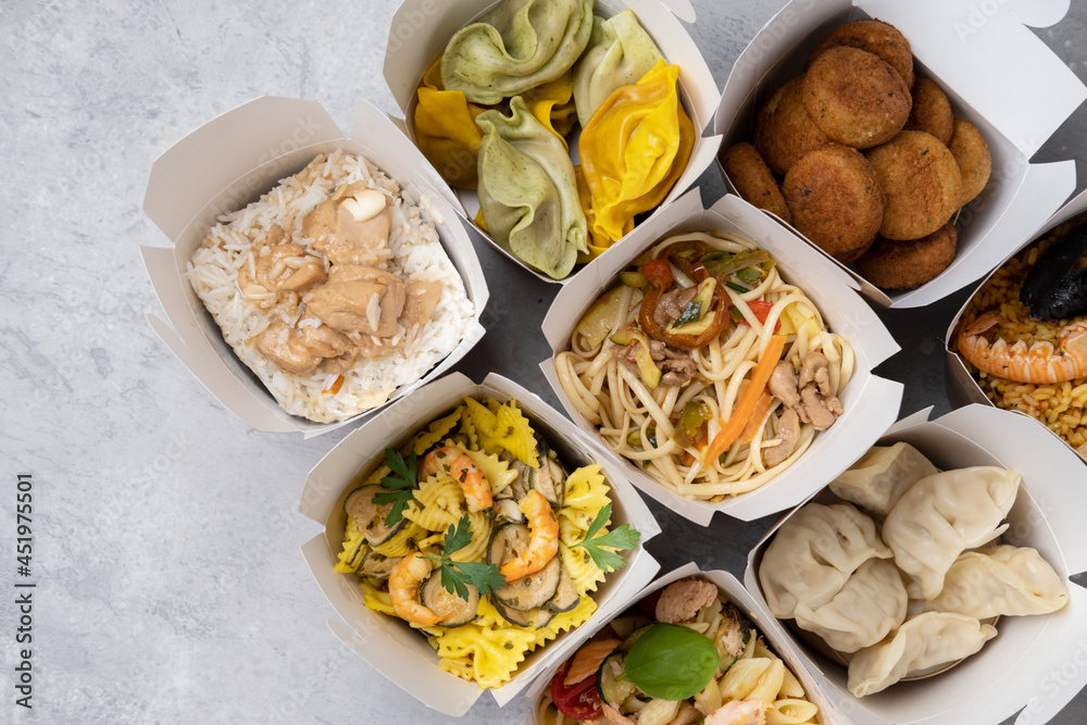 Сhinese takeaway food, italian food delivery. Different lunch wok box with dumplings, noodles with chicken, rice with chicken, pasta with salmon