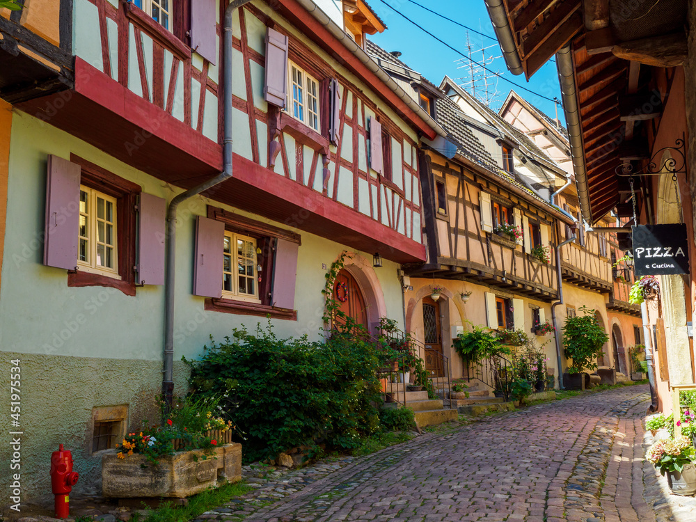 Obraz premium Street with colorful traditional french houses in Eguisheim, France