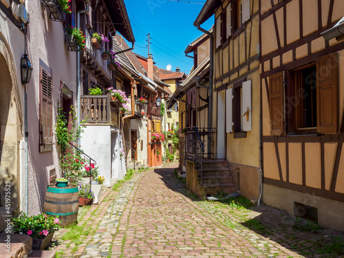 Street with colorful traditional french houses in Eguisheim, France