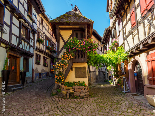 Street with colorful traditional french houses in Eguisheim, France