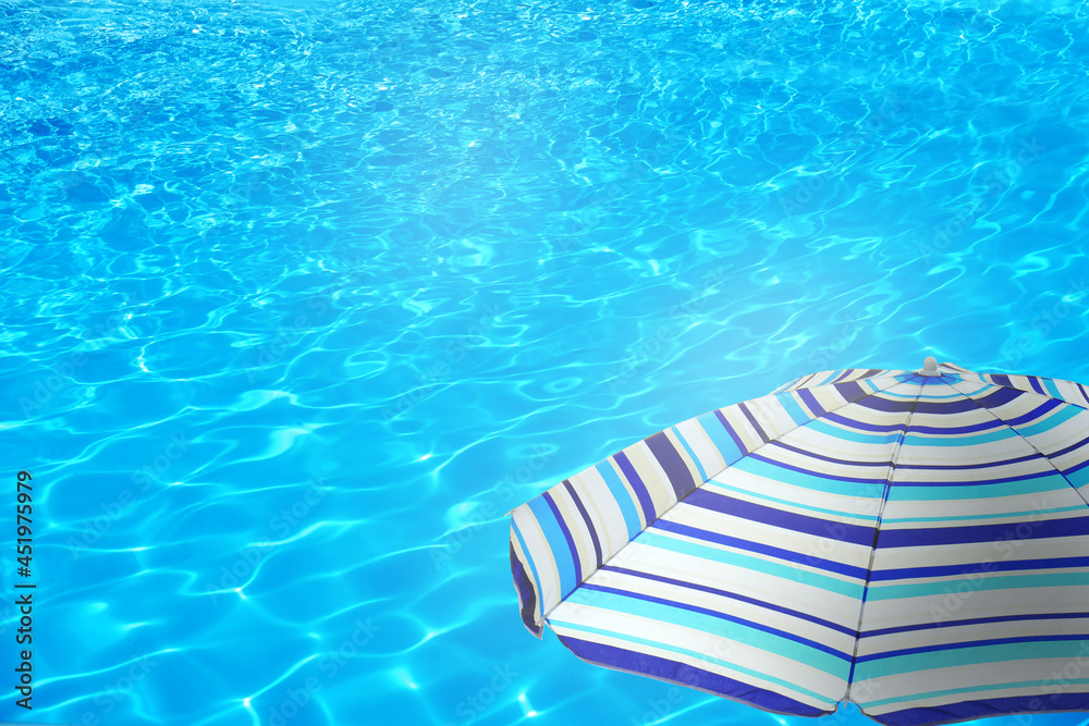 Obraz premium Open beach umbrella and swimming pool. Summer vacation