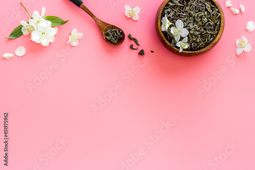 Jasmine hearbal tea in bowl with flowers. Overhead view photo