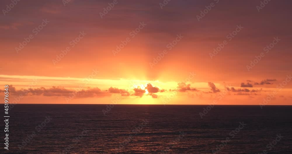 dark sea covered with the last rays of the setting sun. beams of the setting sun piercing through dramatic clouds dark sea covered with the last rays of the setting sun. beams of the setting sun piercing through dramatic clouds