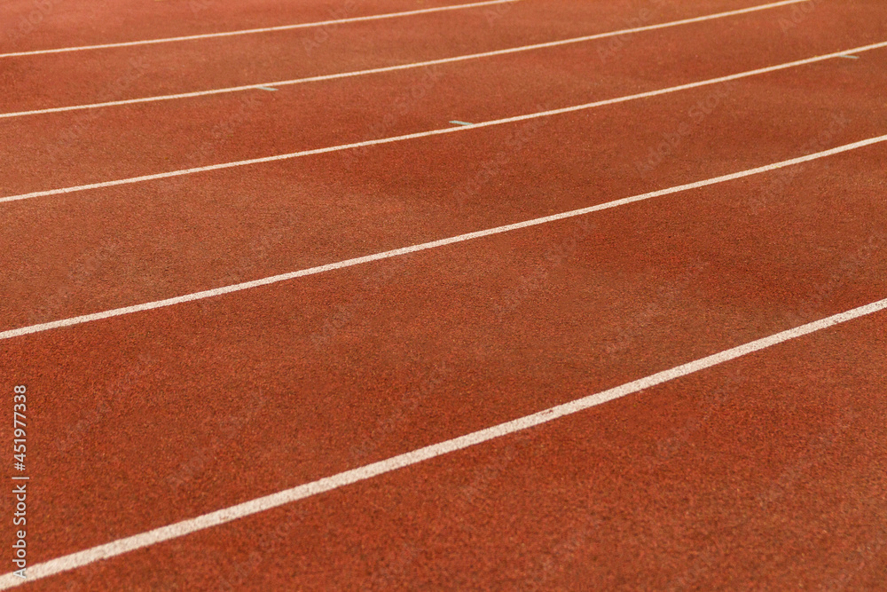 Running track on athletic stadium. Artificial surface for track and field athletics.