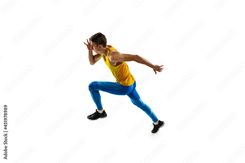 Caucasian professional male athlete, runner training isolated on white studio background. Muscular, sportive man. Concept of action, motion, youth, healthy lifestyle.