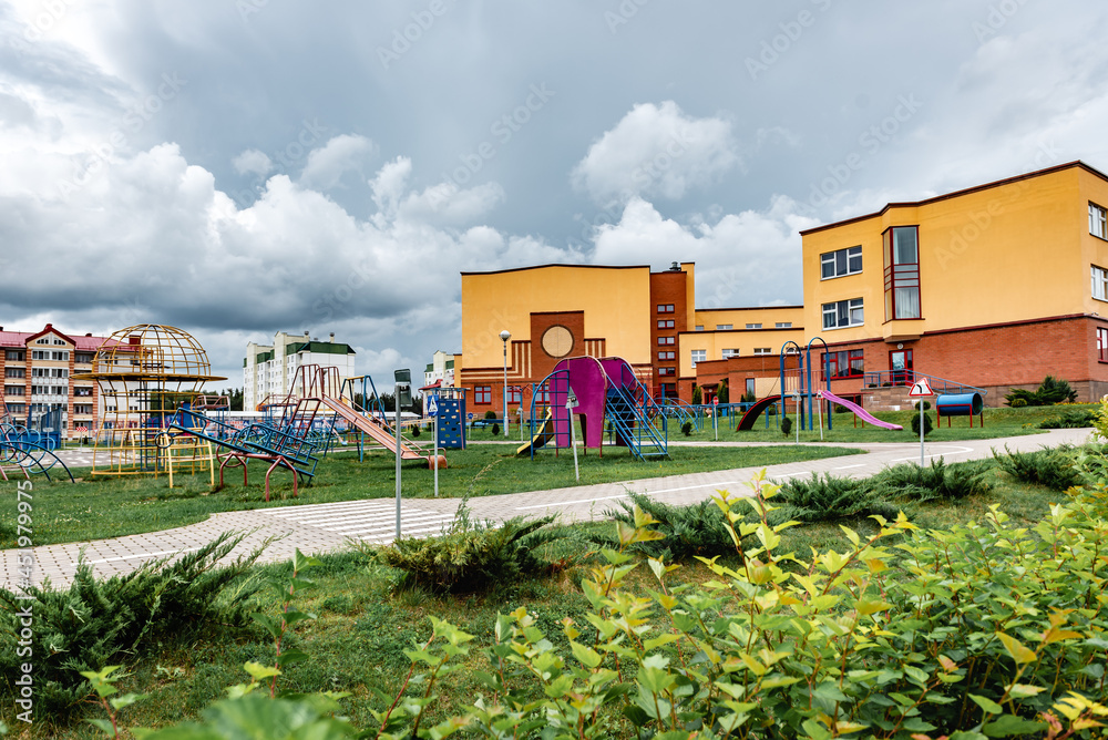 Exterior view of modern public school building with playground.
