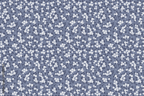 Beautiful floral pattern in small abstract flowers. Small white flowers. Gray background. Ditsy print. Floral seamless background. The elegant the template for fashion prints. Stock pattern.