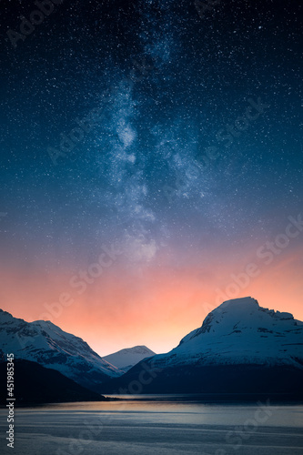Epic mountain landscape with stars of the milky way above dramatic sunset. Ethereal spirituality. © Jamo Images