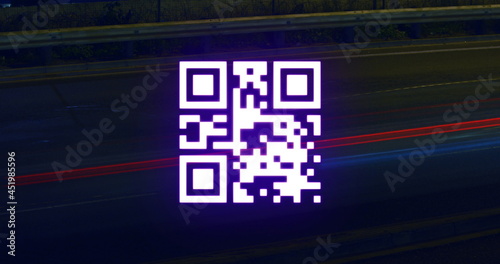 QR code scanner against light trails on black background