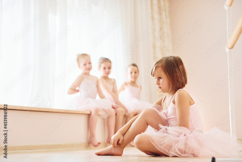 Practicing on the floor. Little ballerinas preparing for performance Practicing on the floor. Little ballerinas preparing for performance