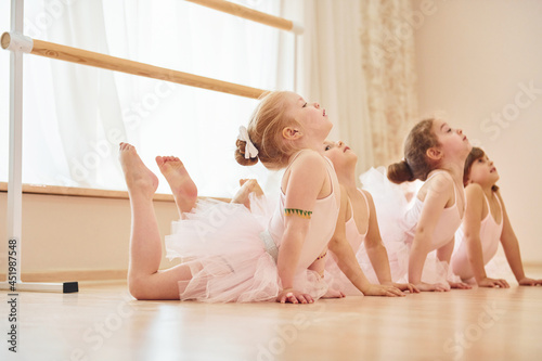 Stretching exercises. Little ballerinas preparing for performance