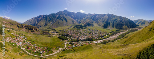 Aerial Panorama of the village of Stepantsminda in summer against the background of the Caucasus Mountains  Georgia