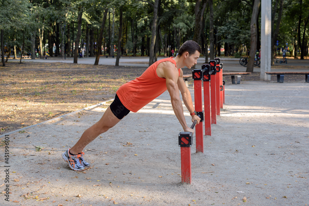 Fototapeta premium young athletic man goes in for sports in the park. outdoor fitness, healthy lifestyle